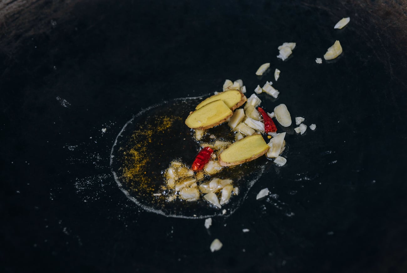garlic, ginger, and chili in oil in wok