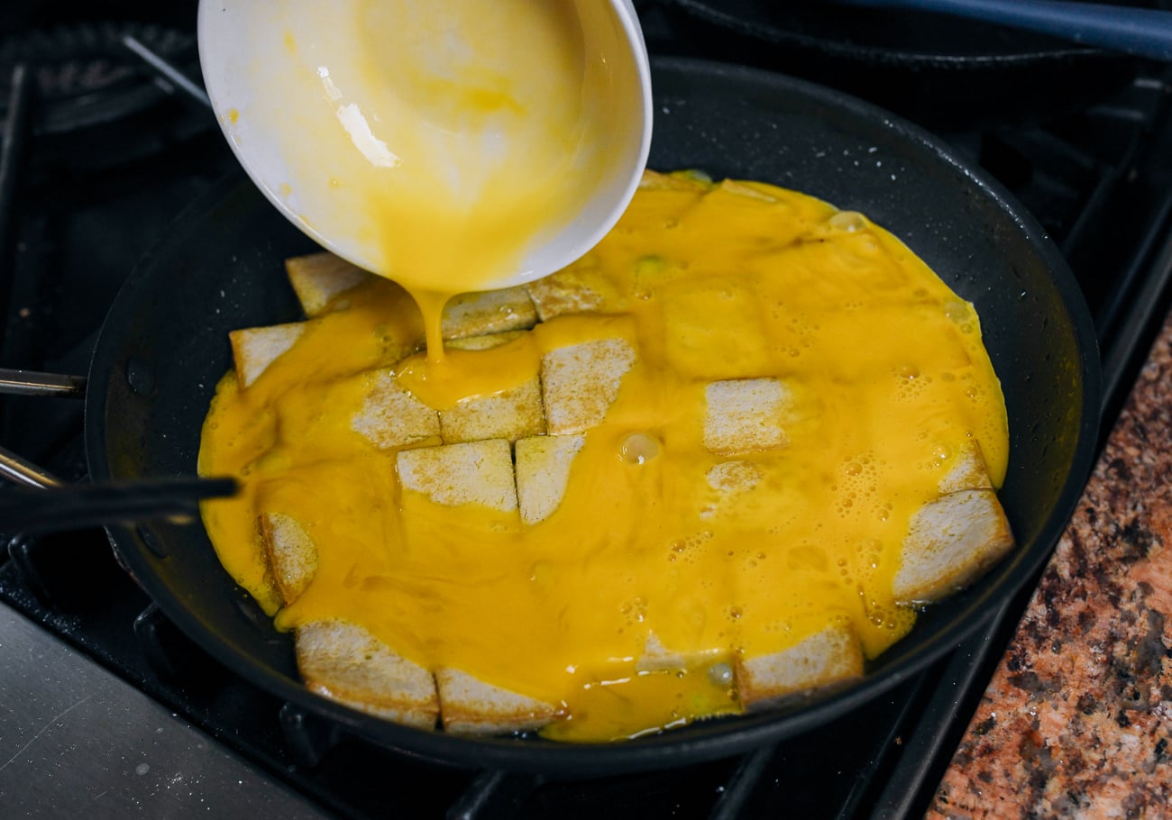 pouring egg over the top of tofu