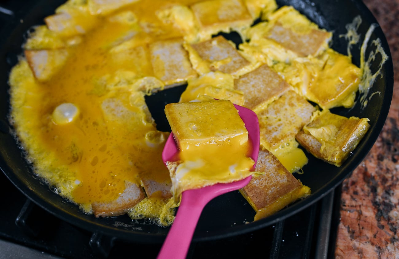 flipping tofu and egg with spatula