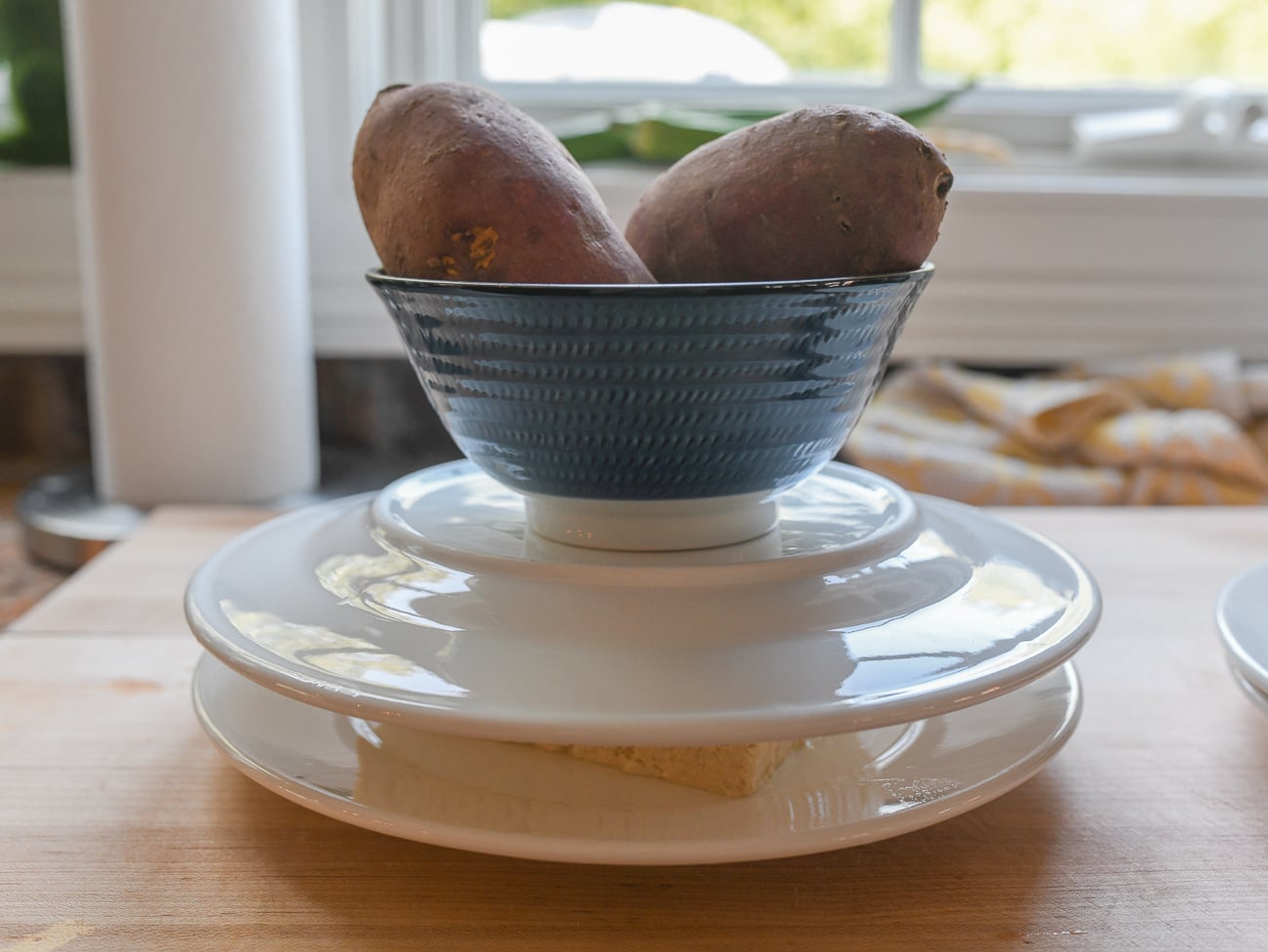 pressing tofu between two plates with something heavy on top