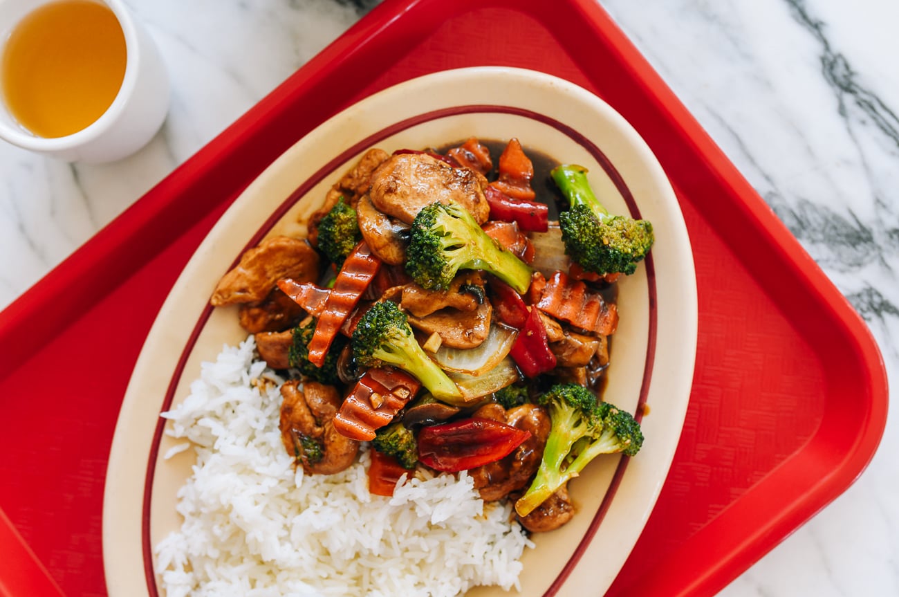 Chicken with mixed vegetables with rice on red tray