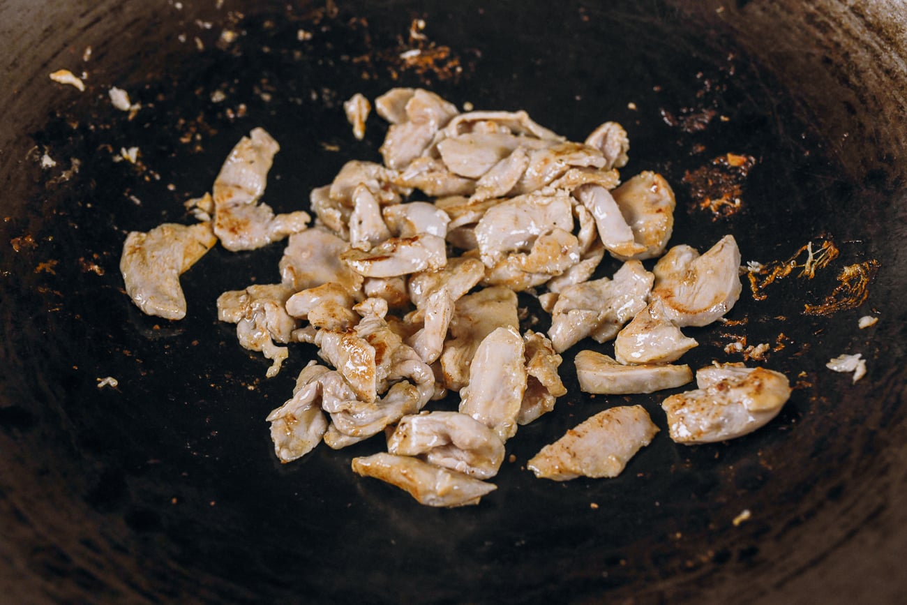 seared chicken slices in wok