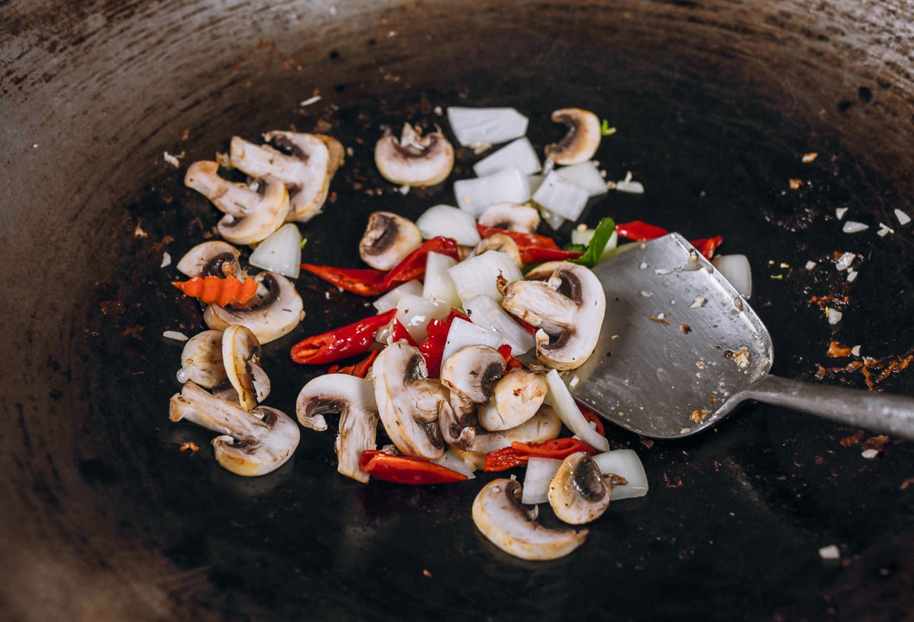 onions, mushrooms and peppers added to wok