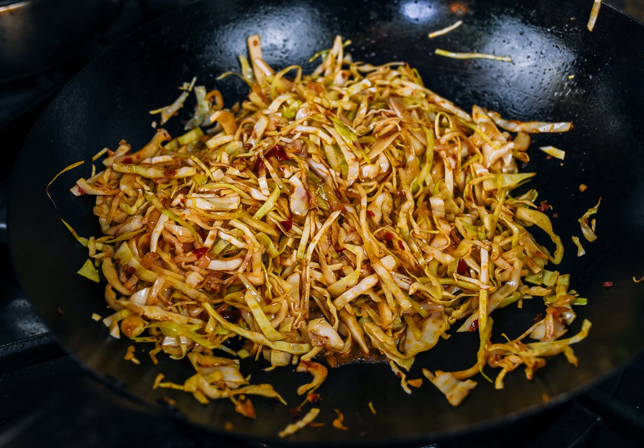 stir-frying shredded cabbage in spicy sauce