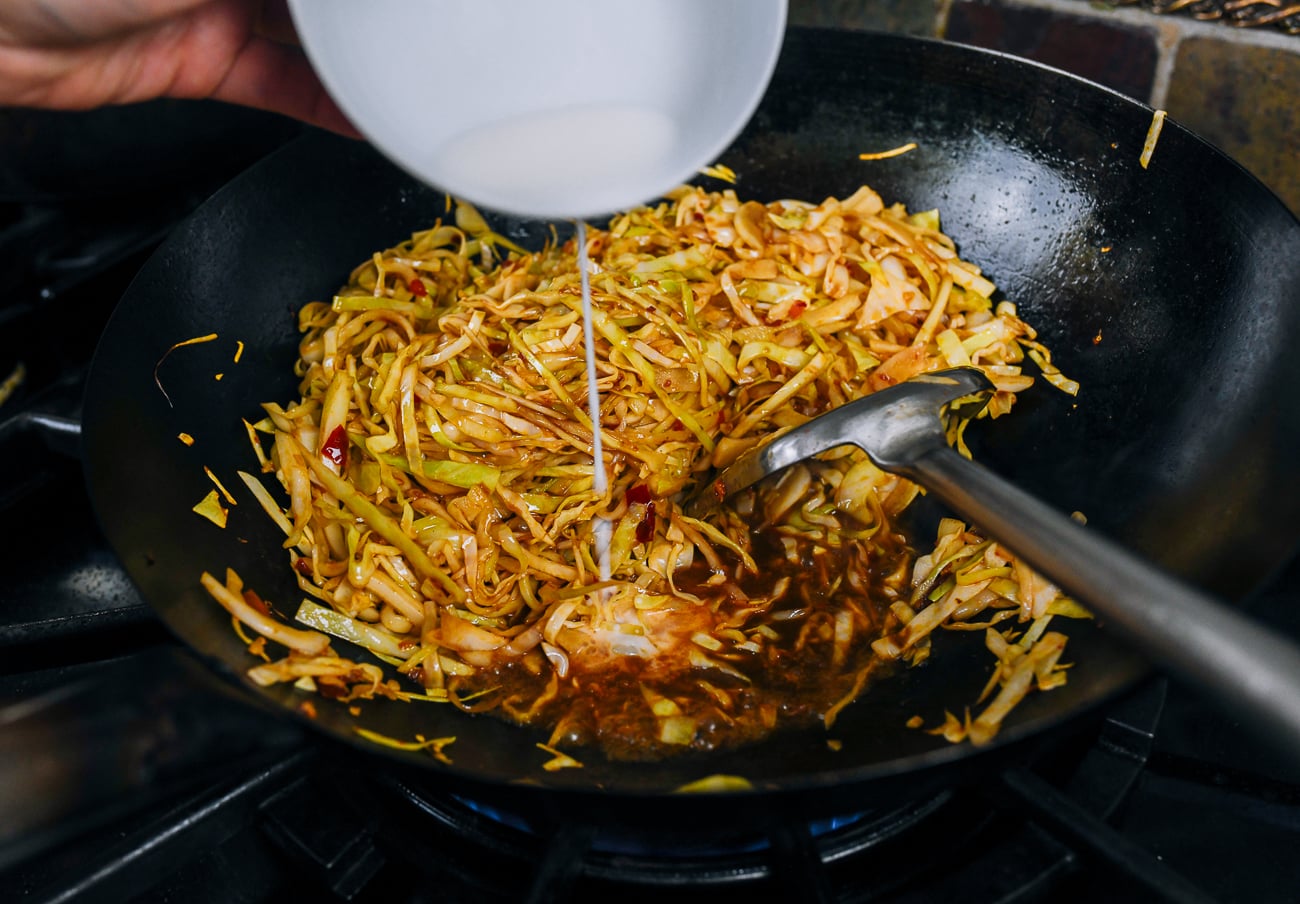 adding cornstarch slurry to cabbage and sauce