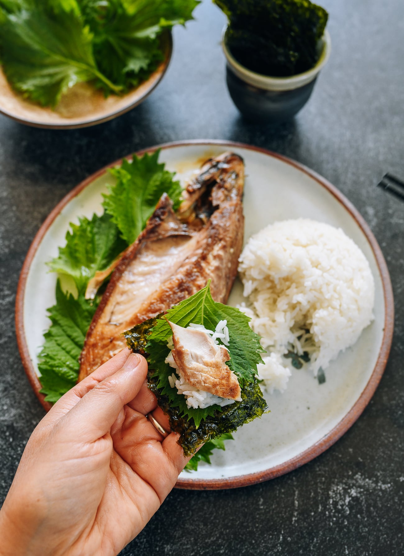 mackerel on a shiso leaf with seaweed and rice