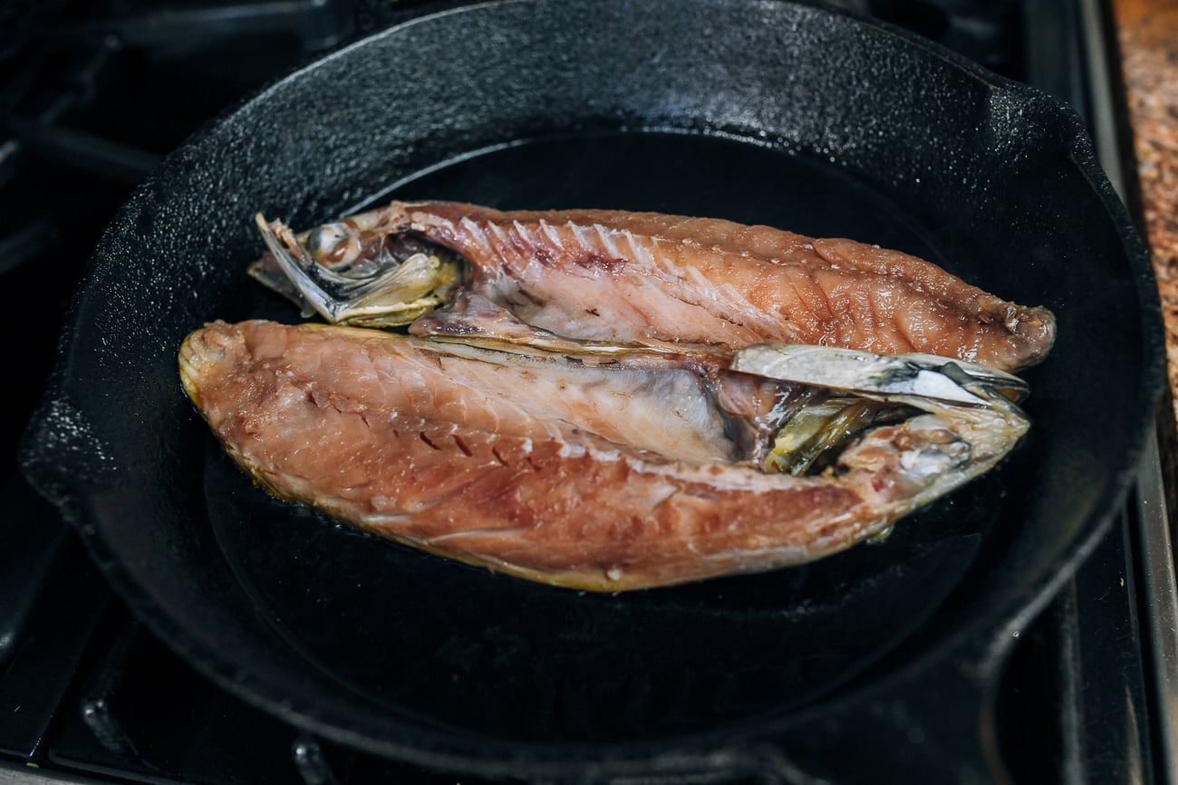 mackerel fillets frying in cast iron skillet