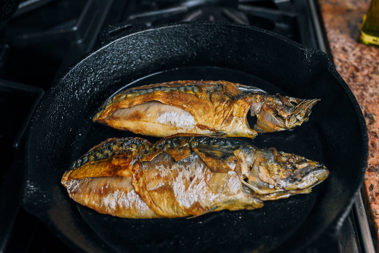 mackerel fillets frying in cast iron skillet