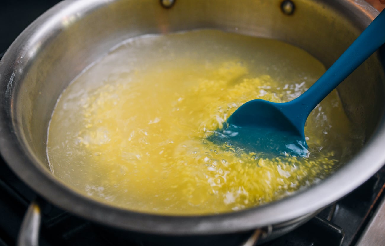stirring millet grains into boiling water