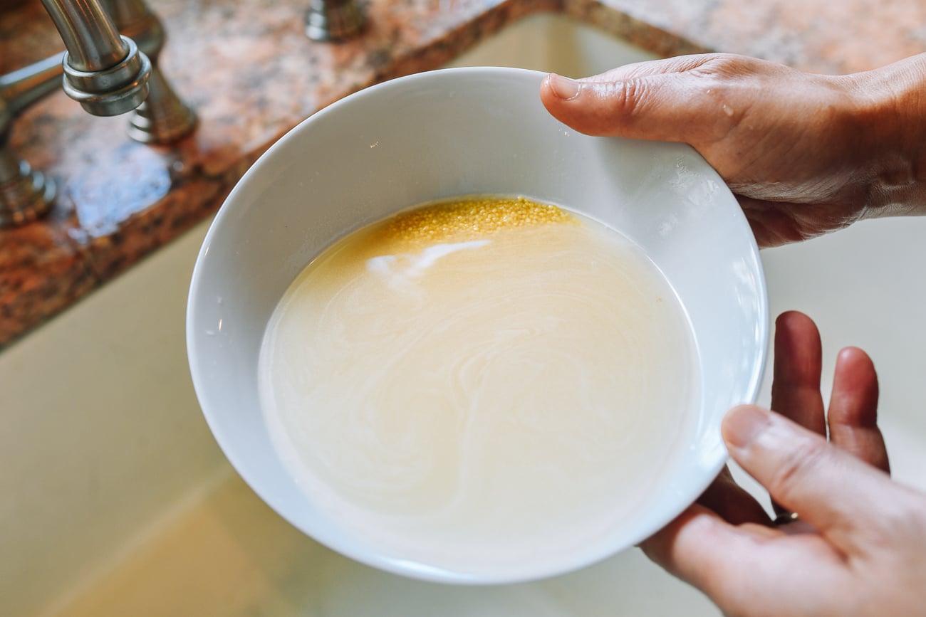 rinsing millet in a bowl