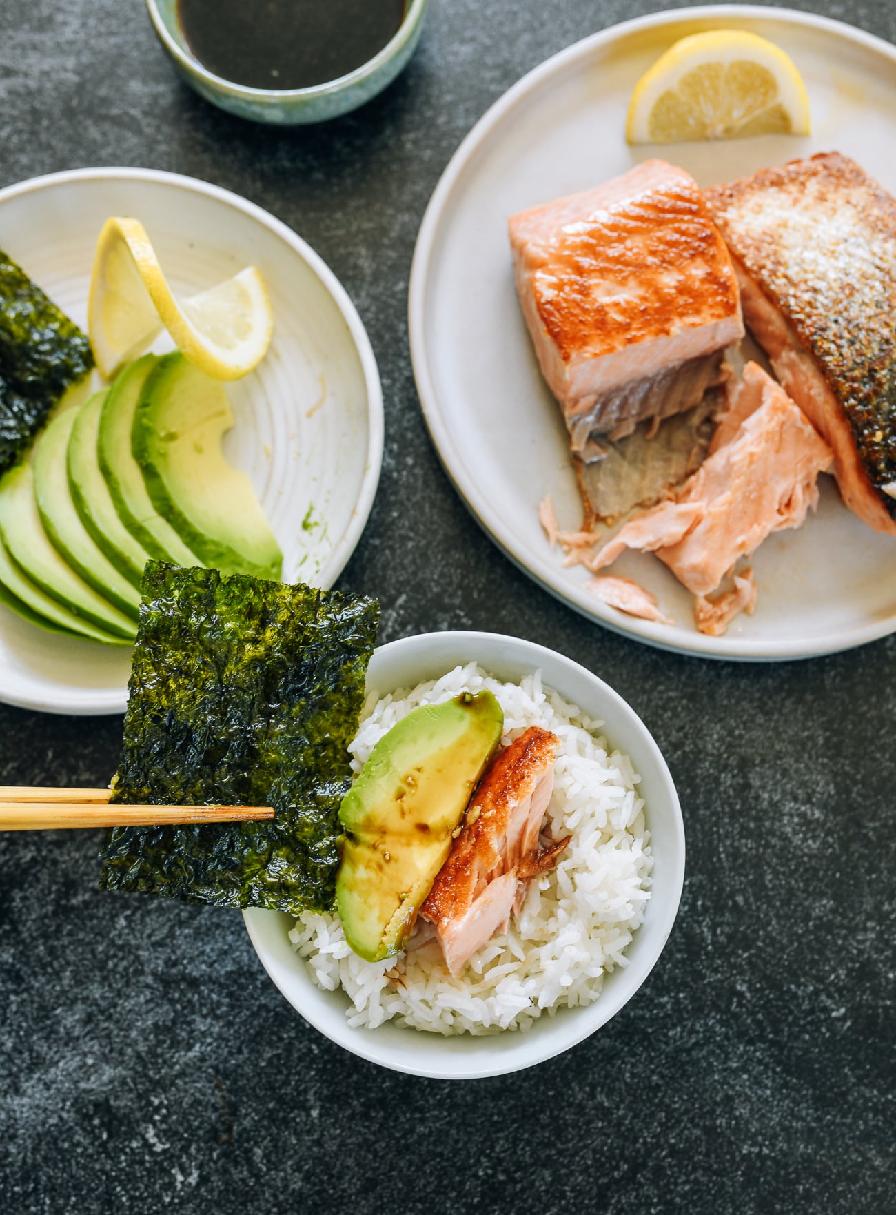 fried salmon with rice, avocado and seaweed