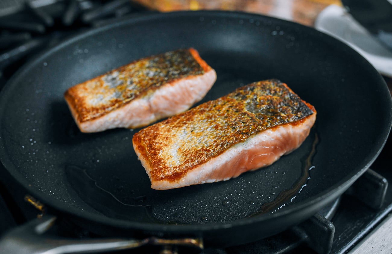 flipped salmon fillets in skillet