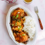 Pork egg foo young on a plate with gravy and rice