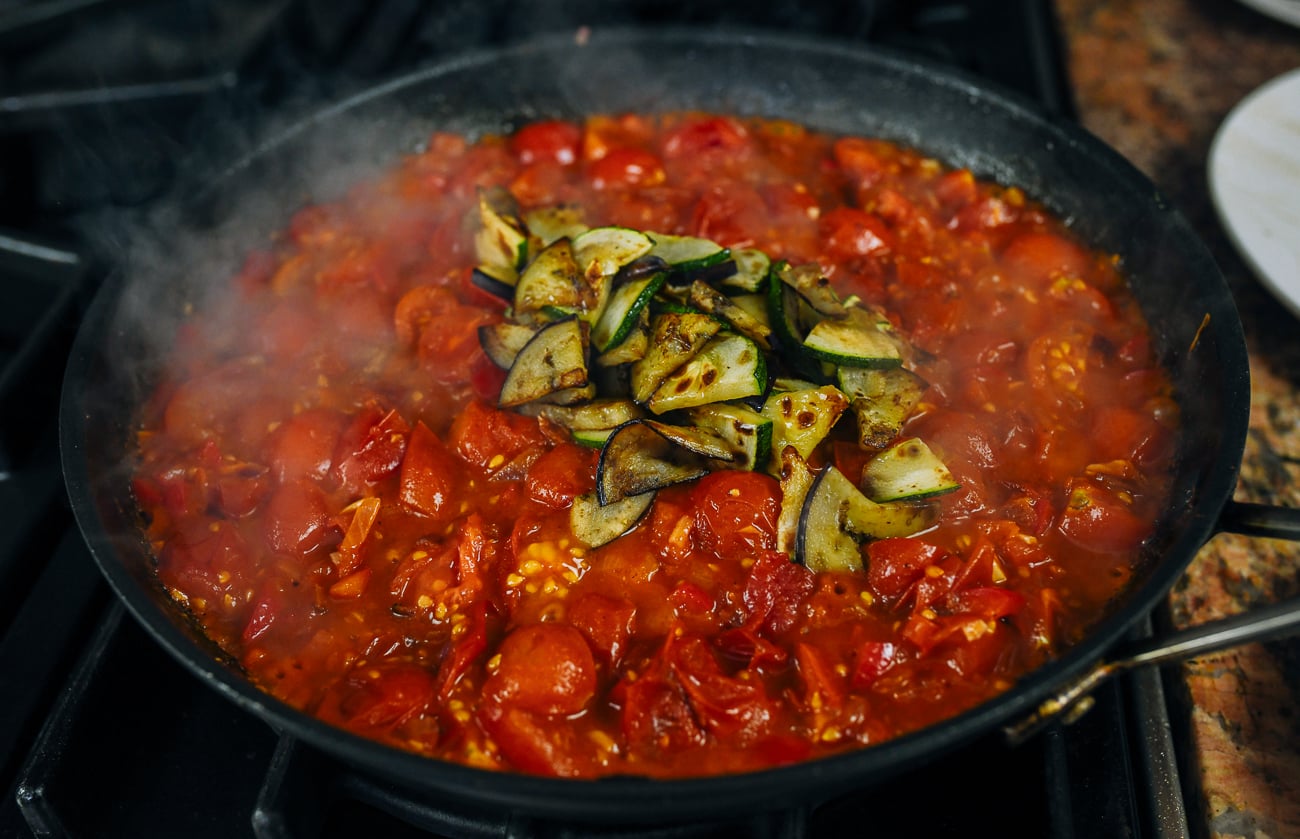 cooked eggplant and zucchini added to shakshuka