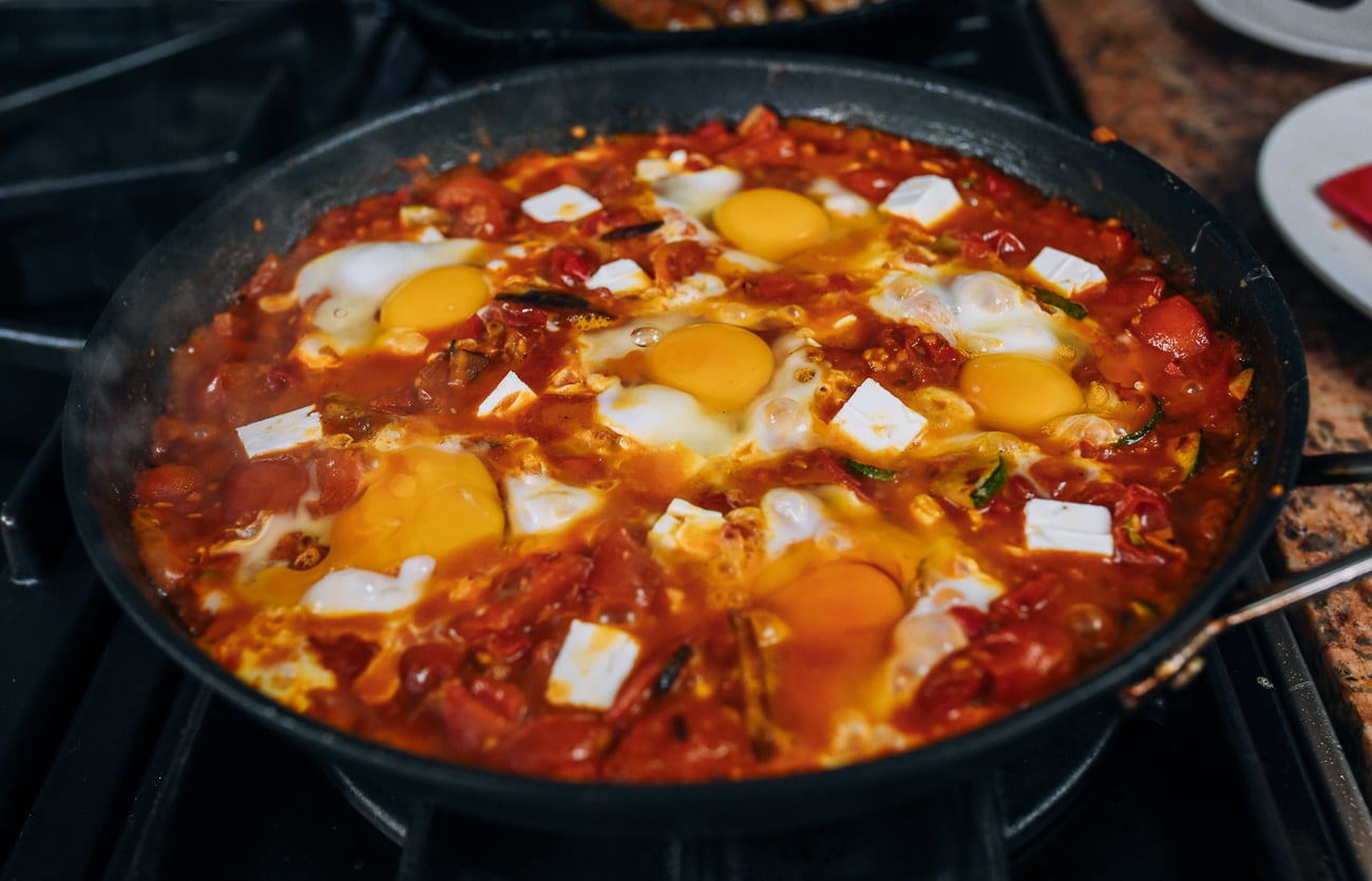 eggs and feta added to shakshuka