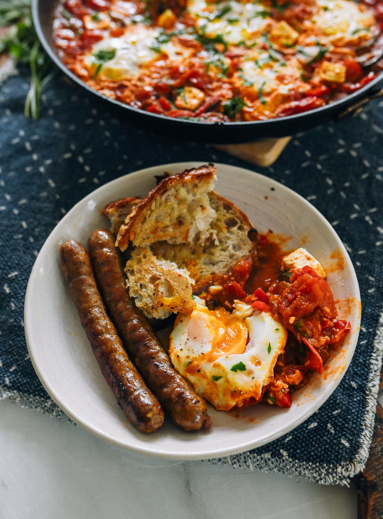 Shakshuka served with merguez and bread