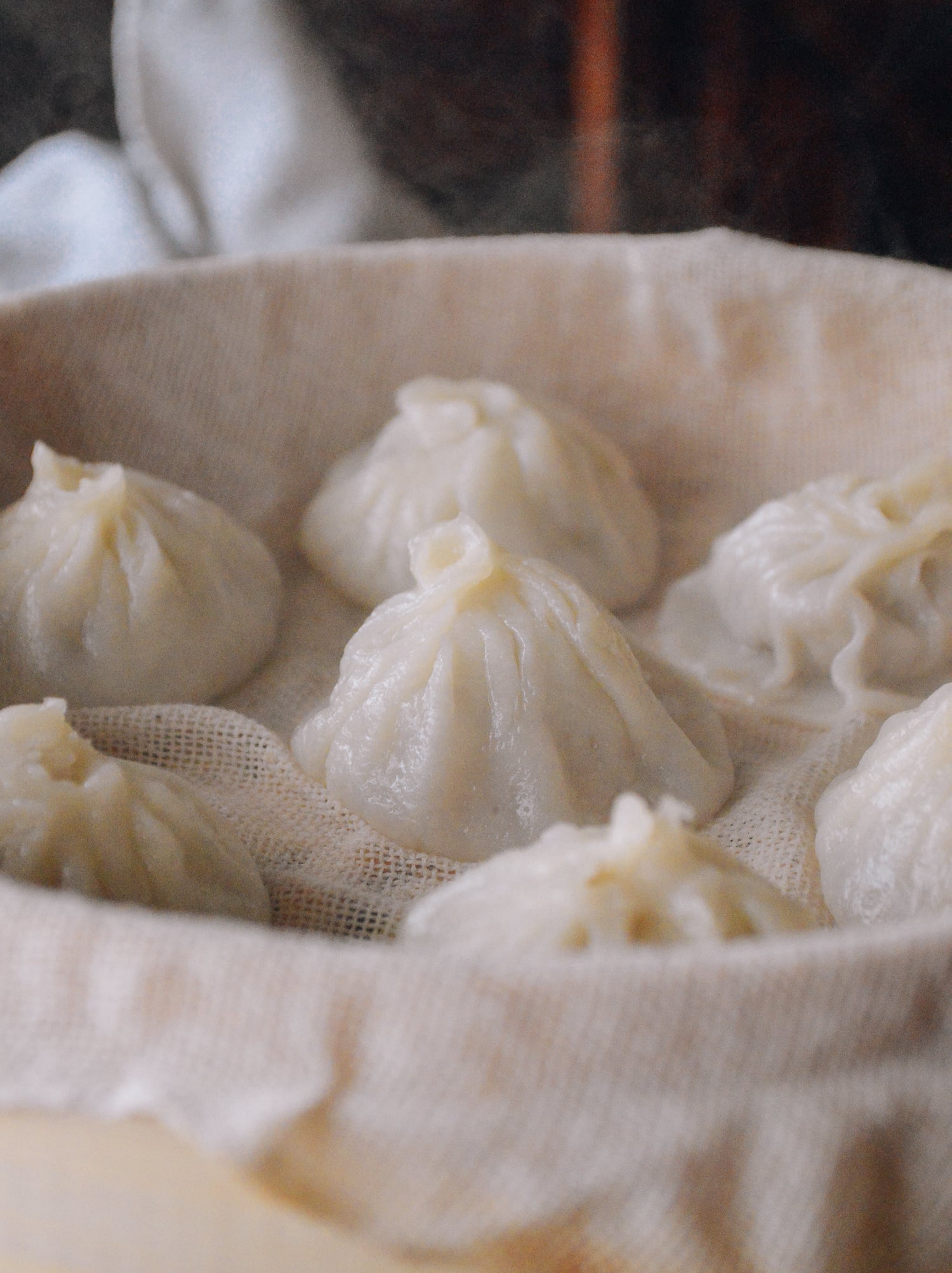 steamed soup dumplings in bamboo steamer