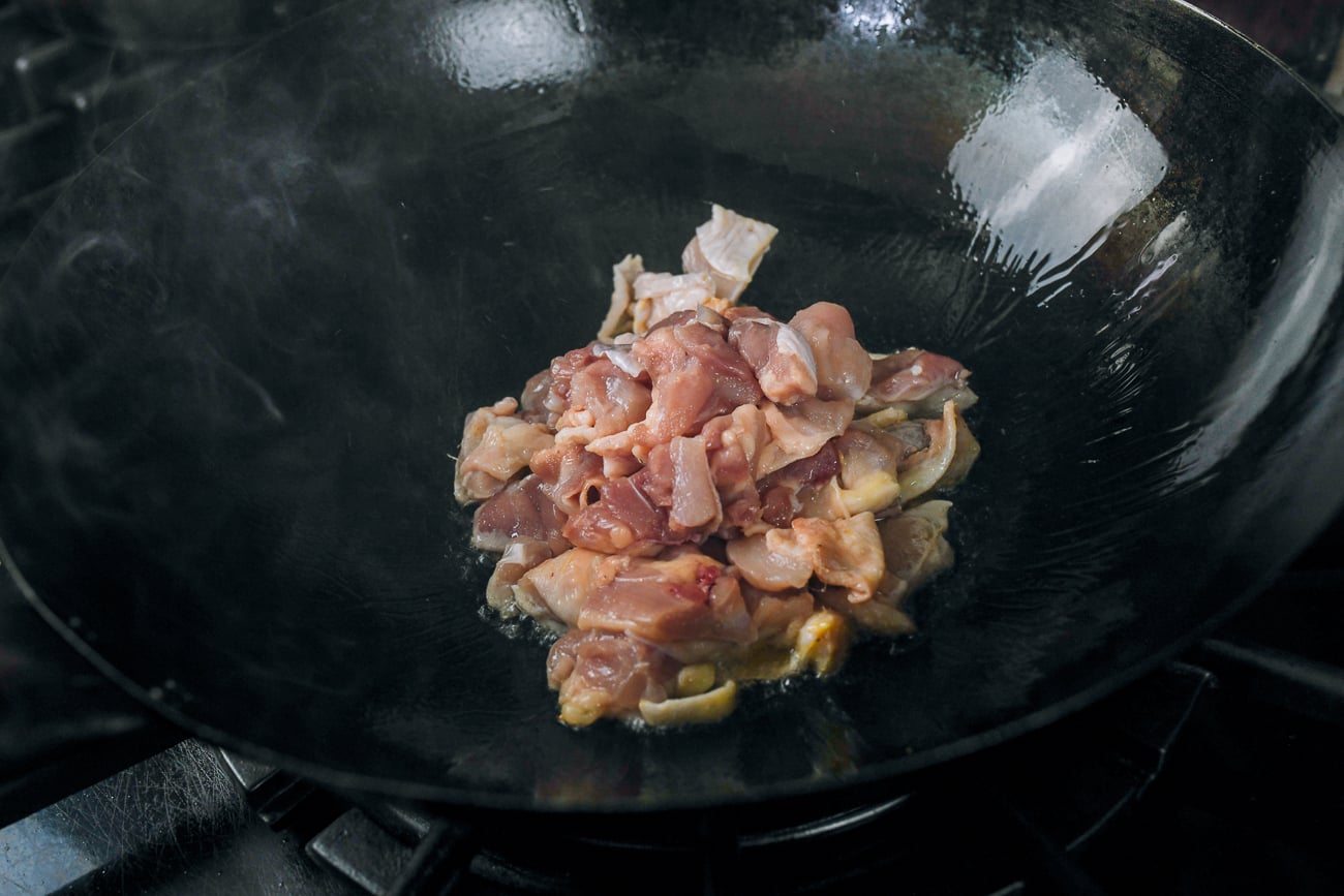boneless skin-on chicken thigh pieces in wok
