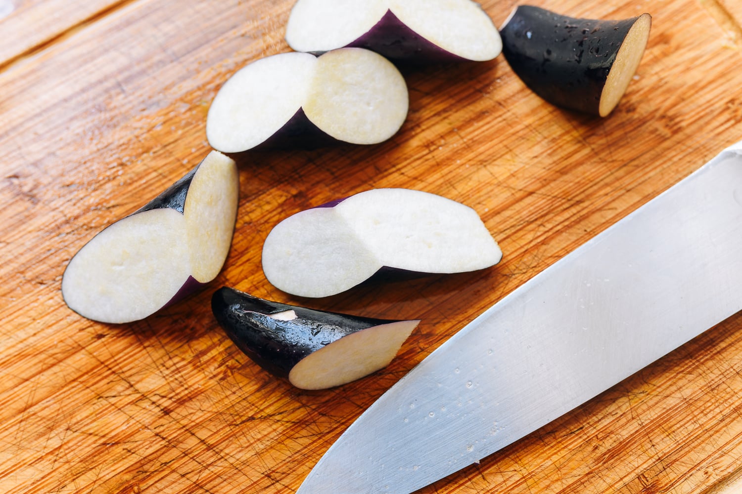 Chinese eggplant cut into pieces on cutting board