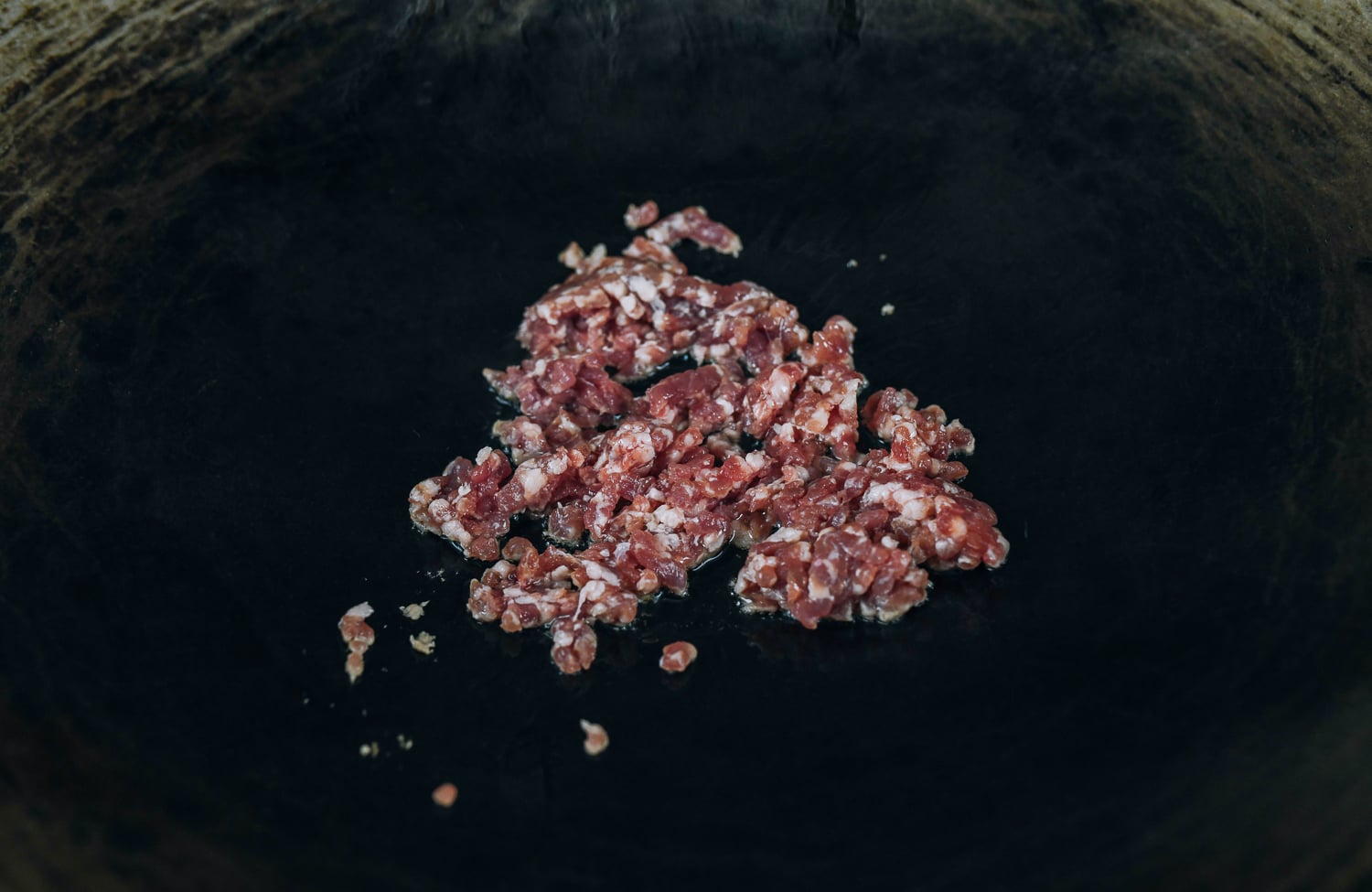 4 ounces of ground pork in wok