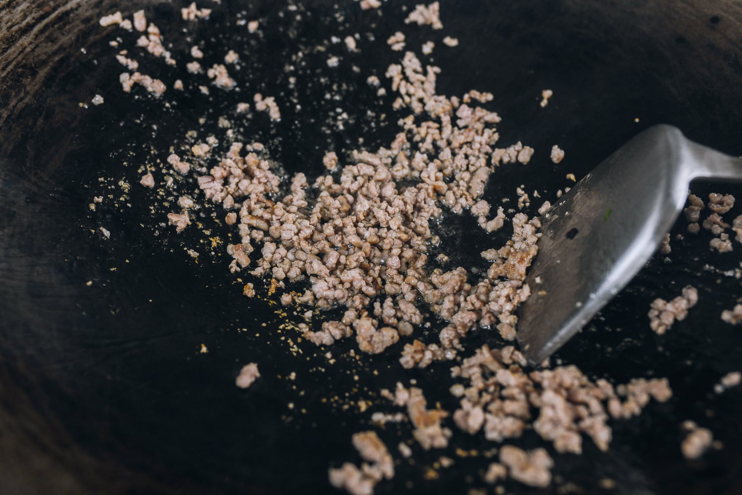 cooking ground pork in wok until opaque