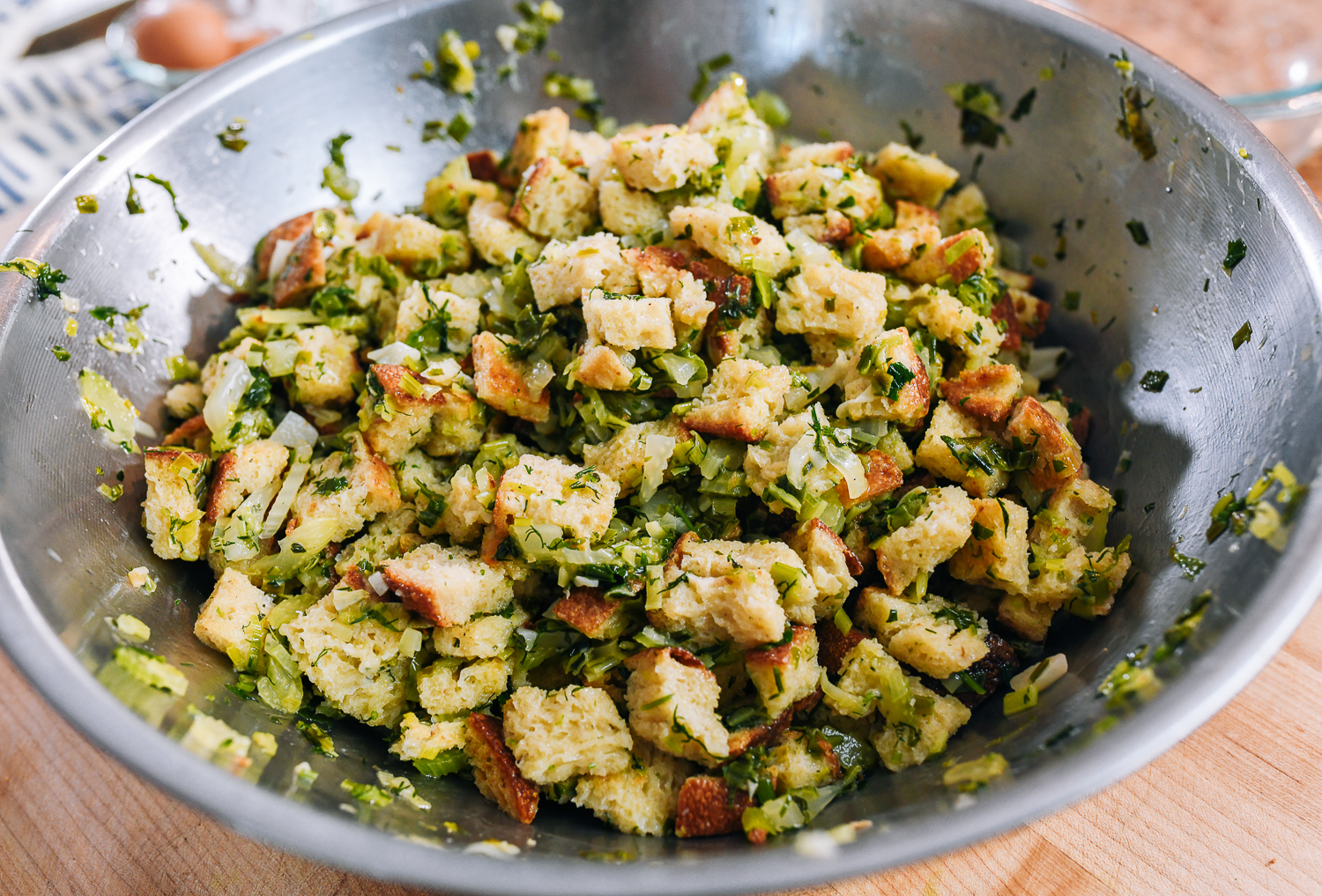 herb stuffing mixture in metal mixing bowl