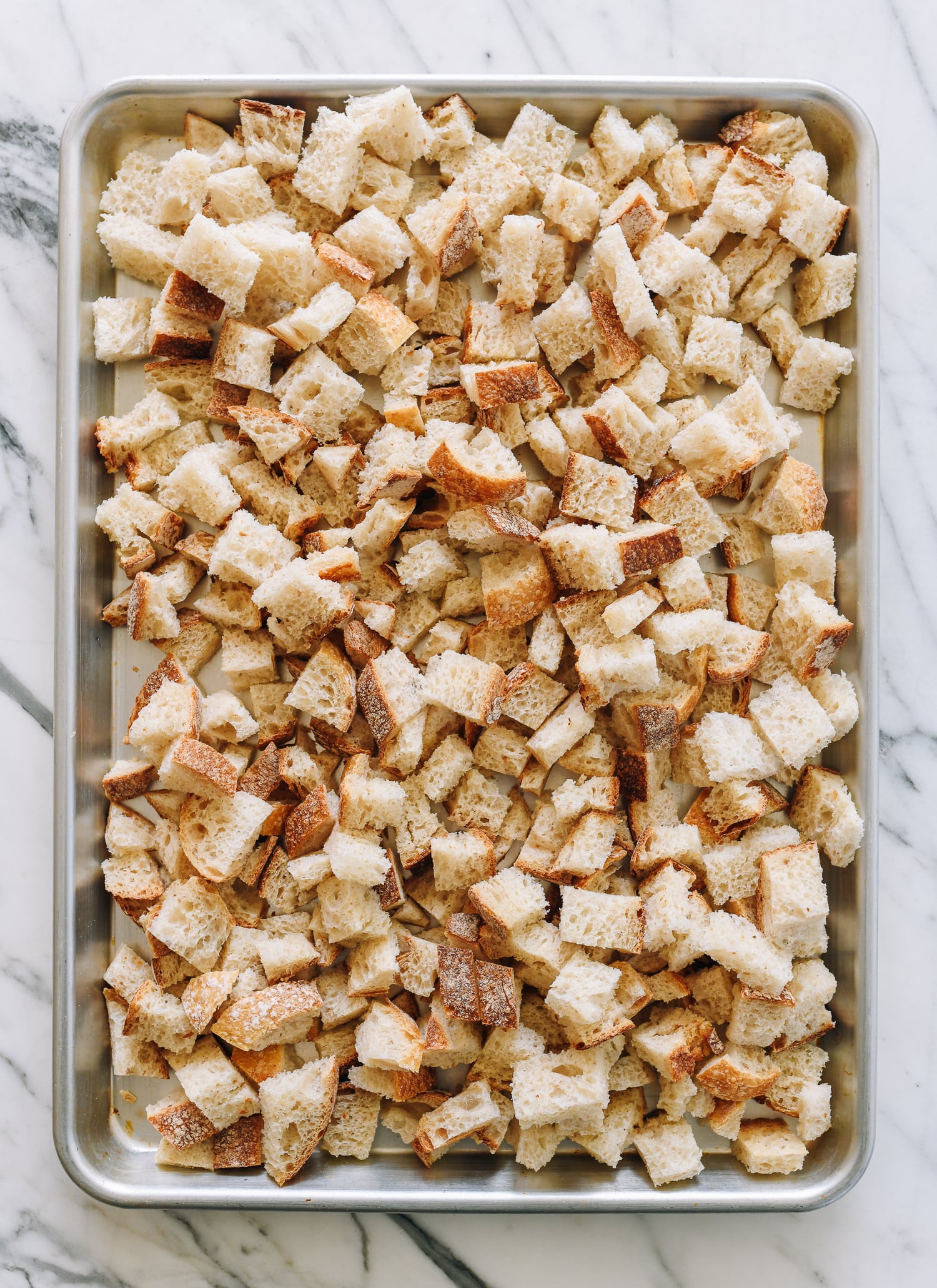 bread cubes on sheet pan