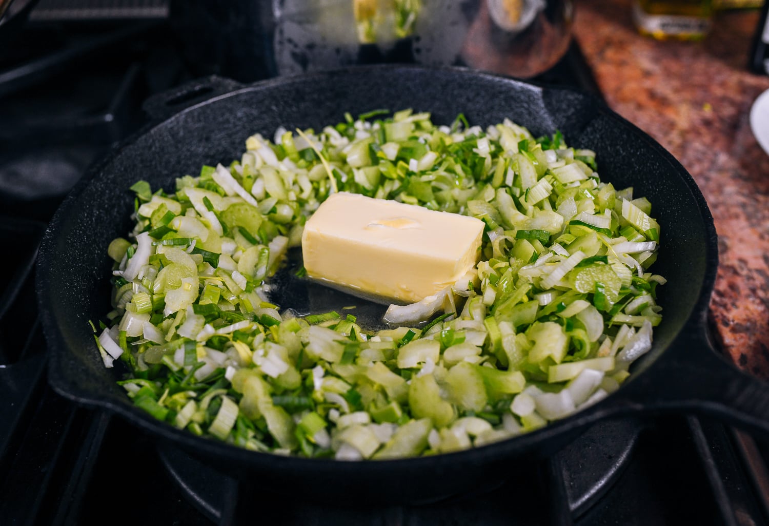 butter melting into cooked chopped celery and leeks