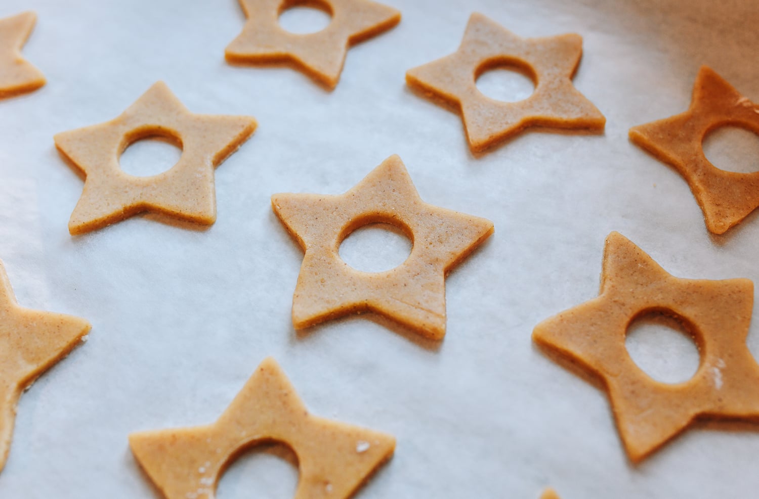 linzer cookie lids on baking sheet before baking