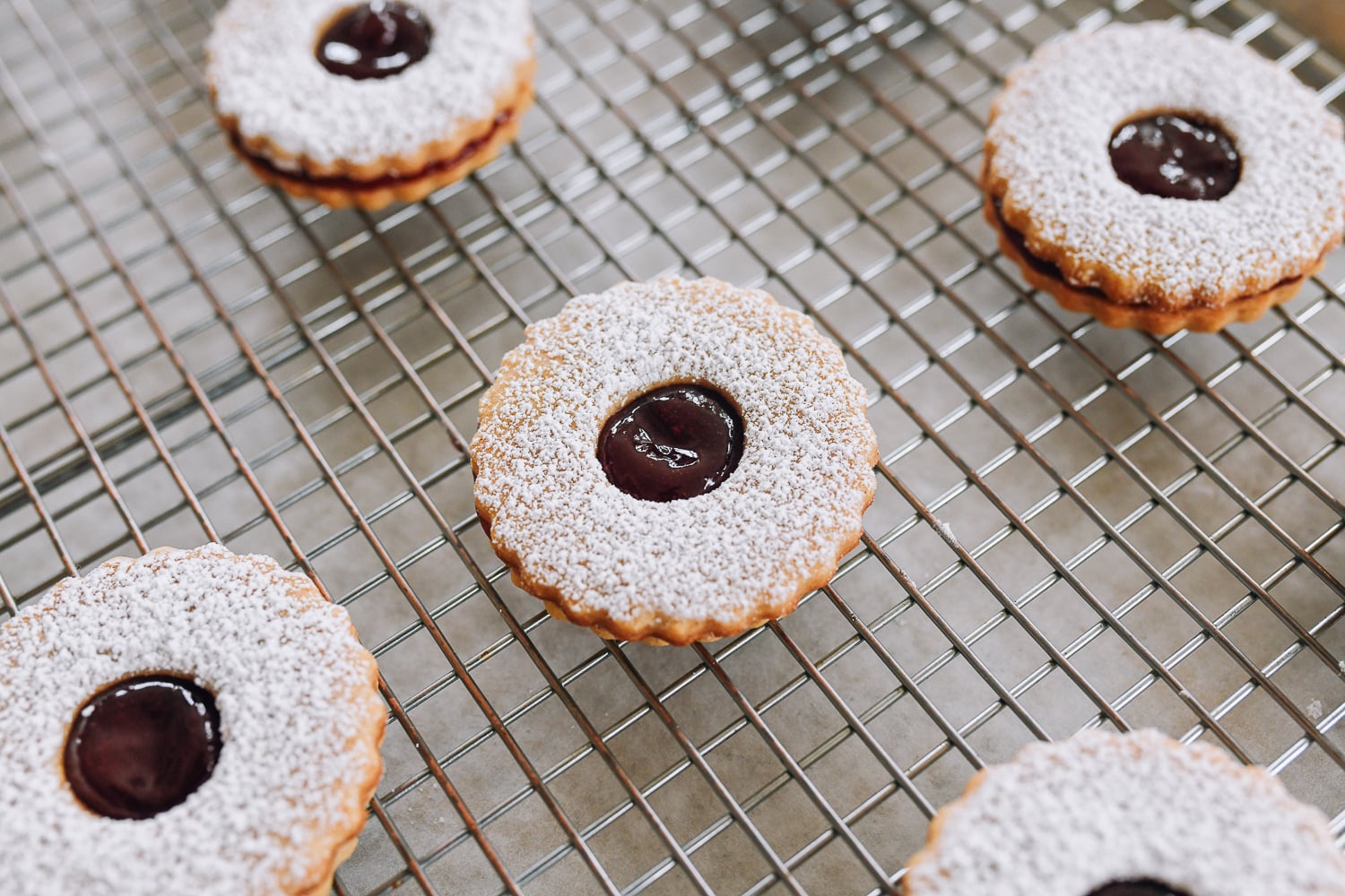 assembled linzer cookies on baking rack