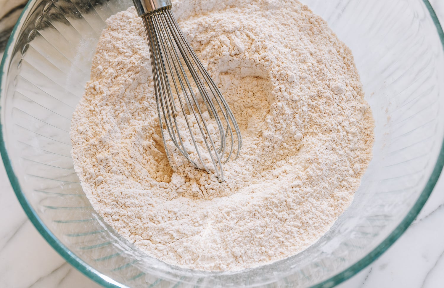 whisking together almond flour, all purpose flour, cinnamon, baking powder, and salt