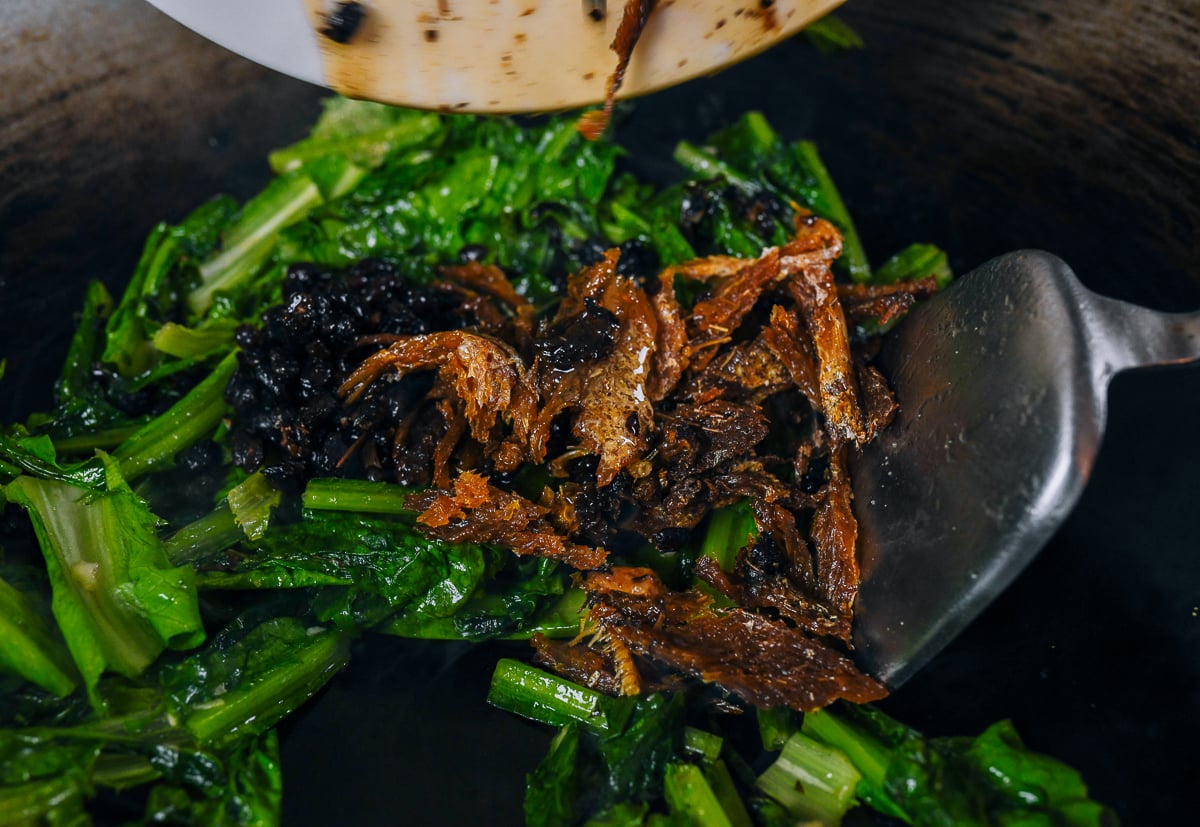 fried dace with salted black beans and veggies in wok