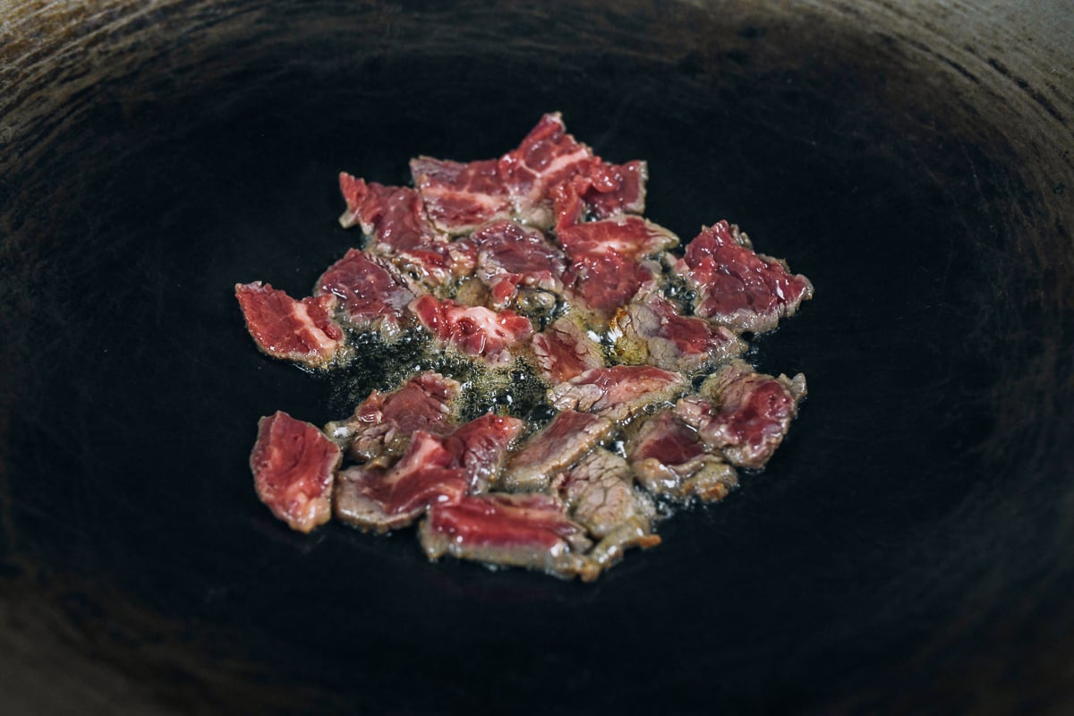 searing sliced flank steak in wok in one layer