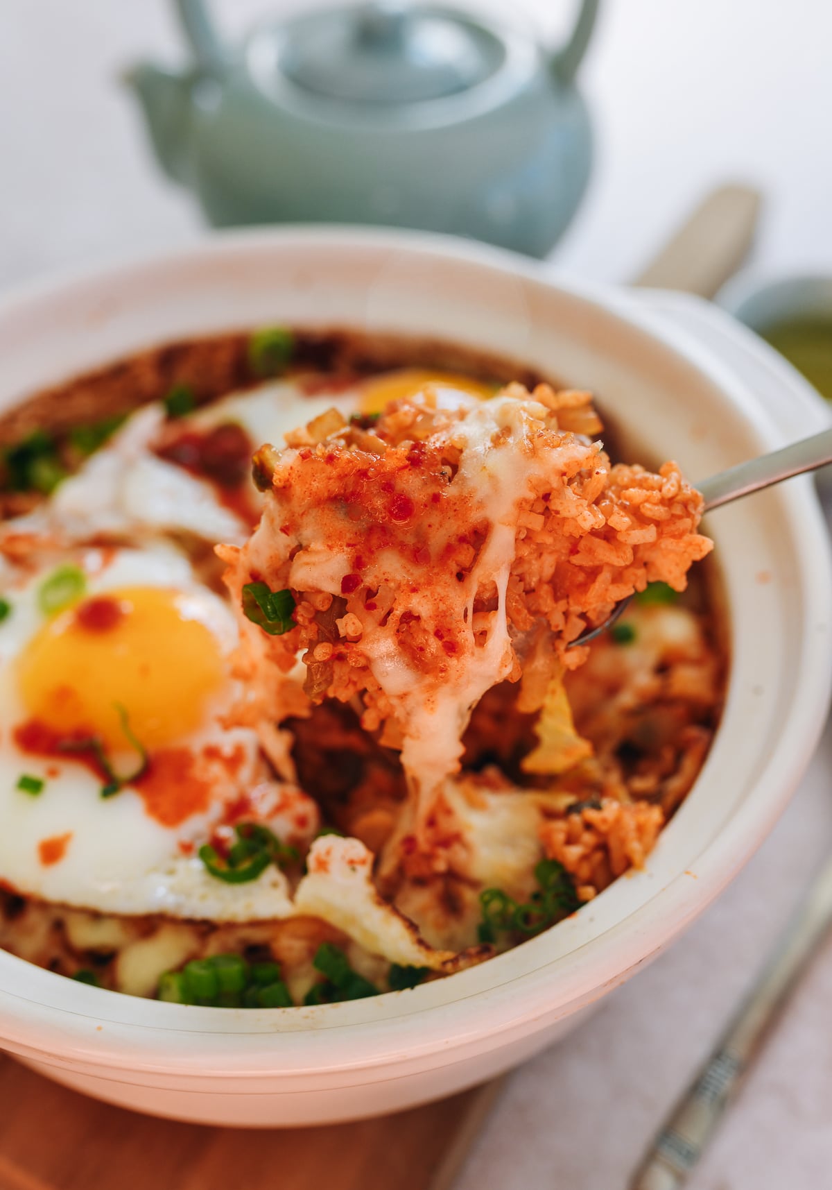 scooping kimchi rice with cheese
