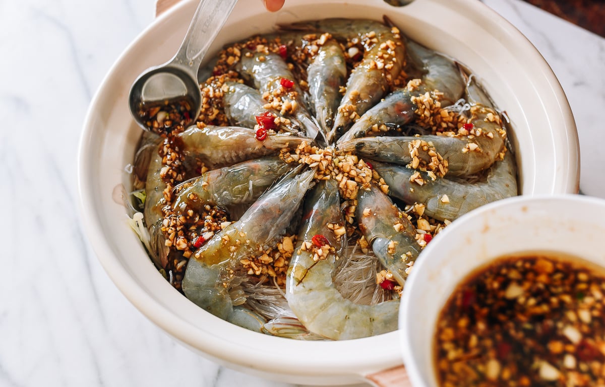 pouring garlic sauce over shrimp