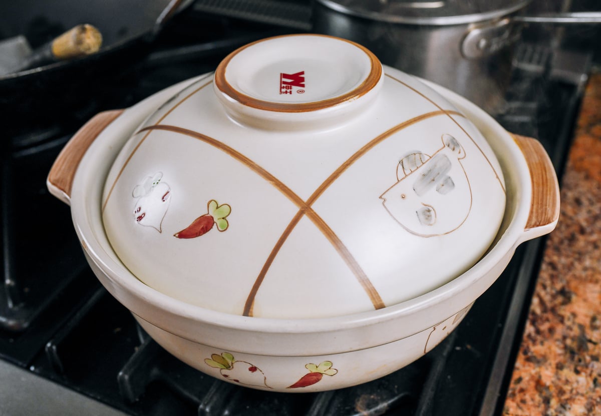 covered clay pot on stove