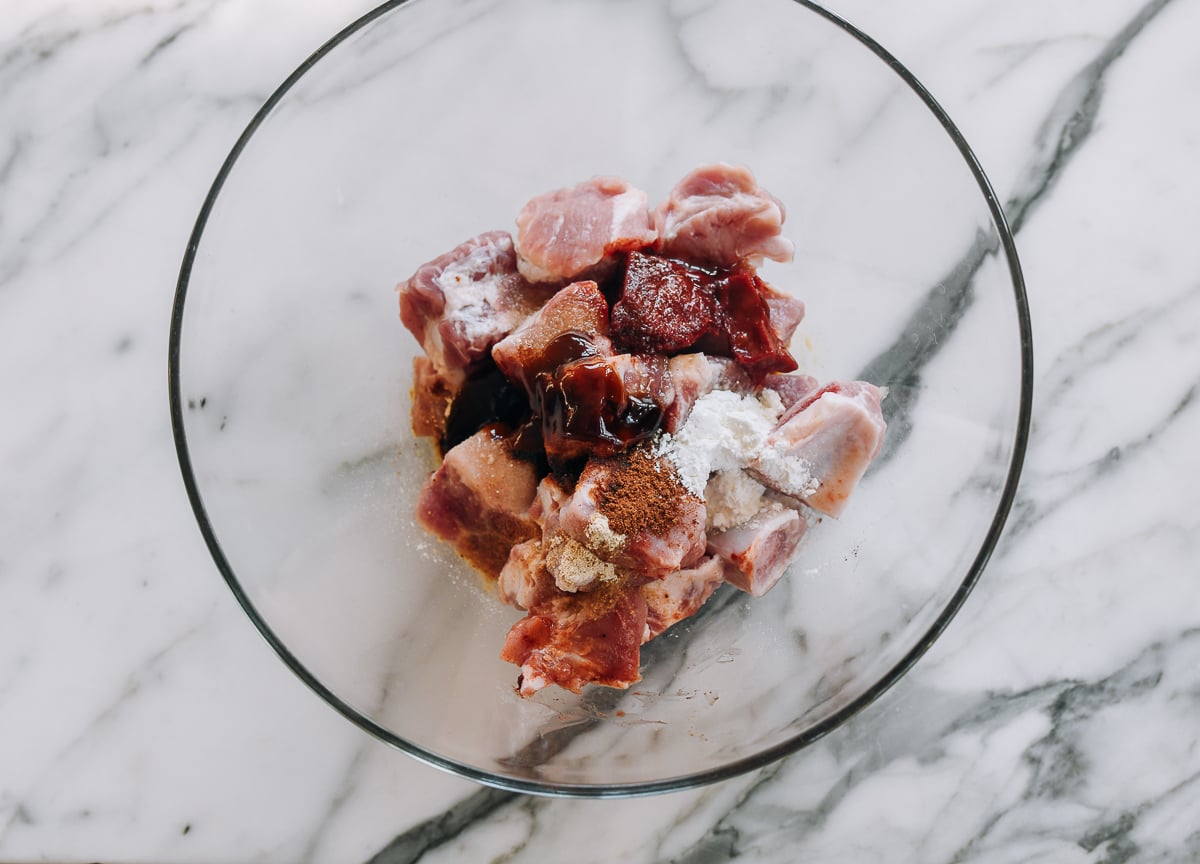 ribs in bowl with red fermented bean curd and other marinade ingredients