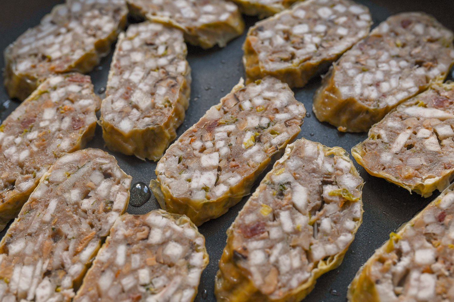 slices of hakka taro roll in frying pan