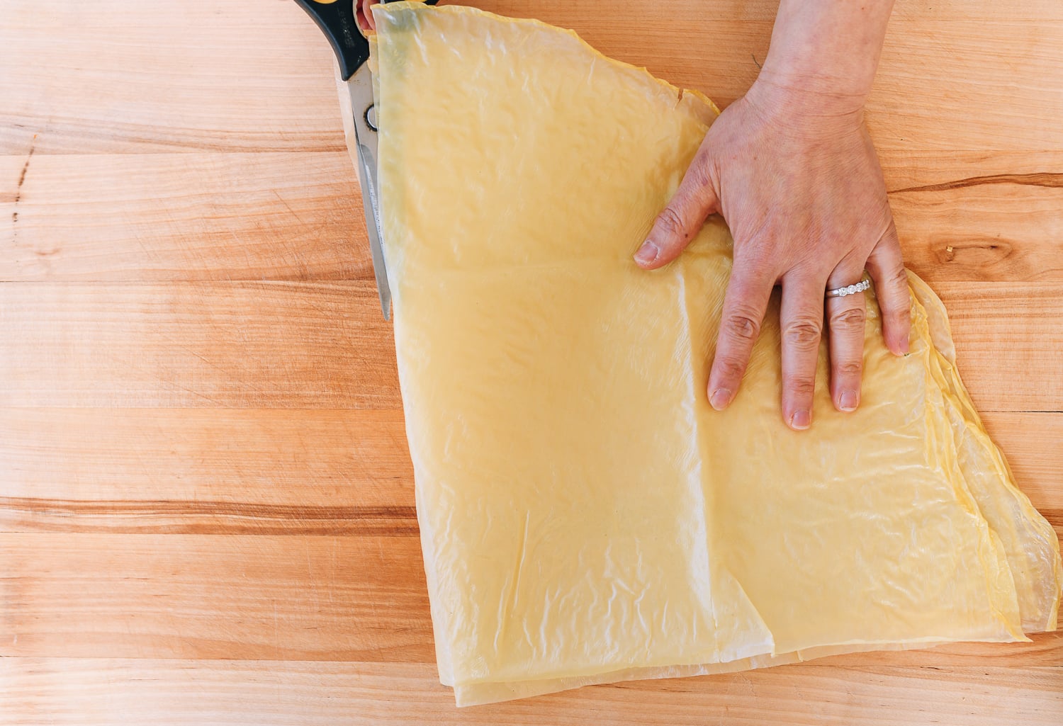 cutting bean curd skin sheet into quarters