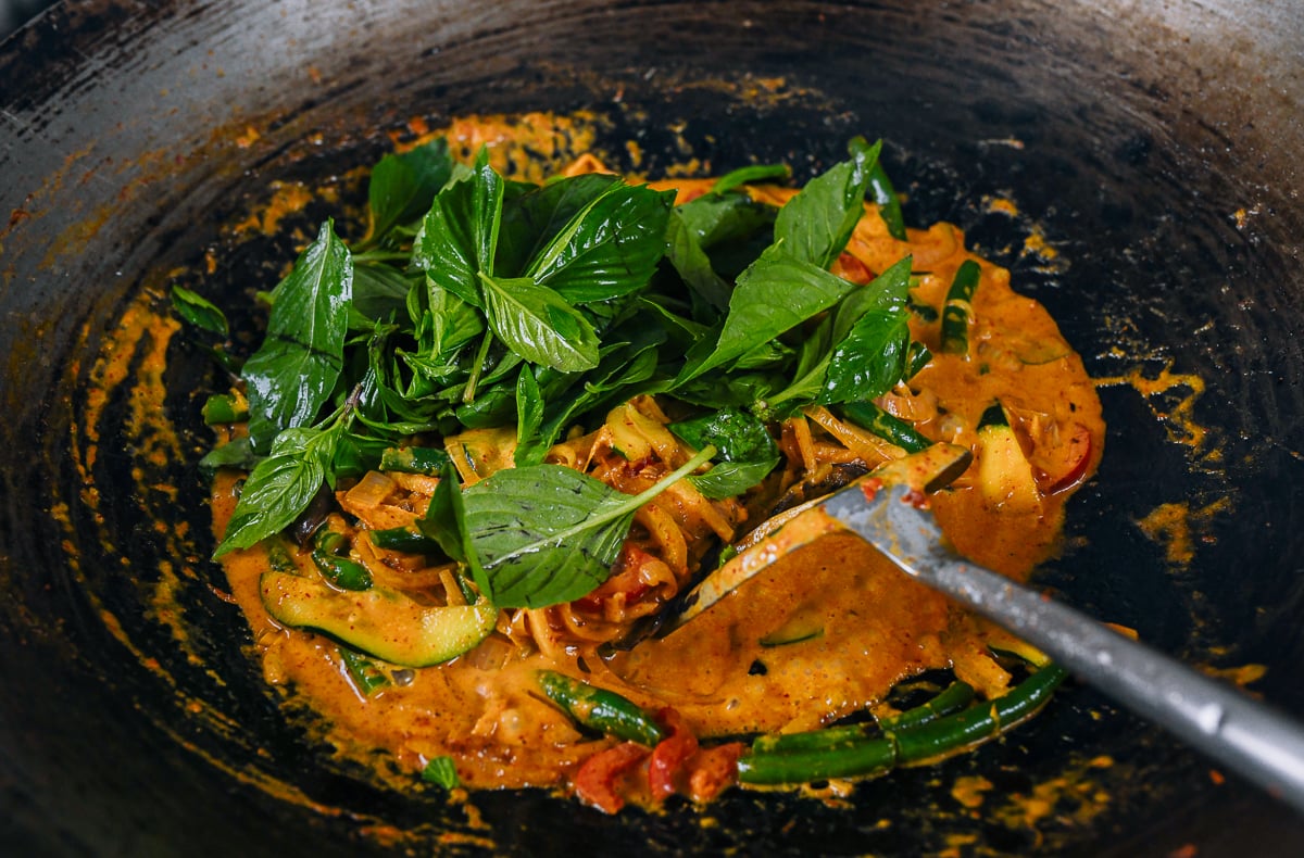 thai basil leaves added to vegetable curry