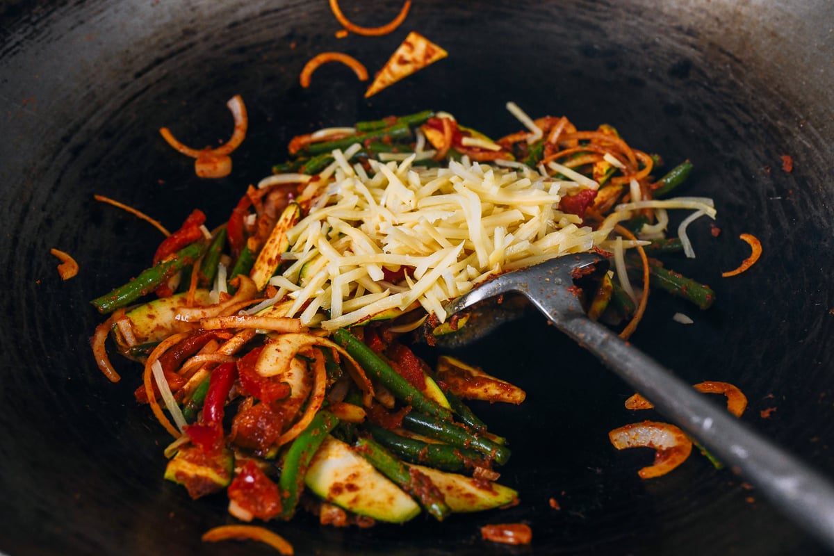 canned julienned bamboo shoots added to other vegetables in wok