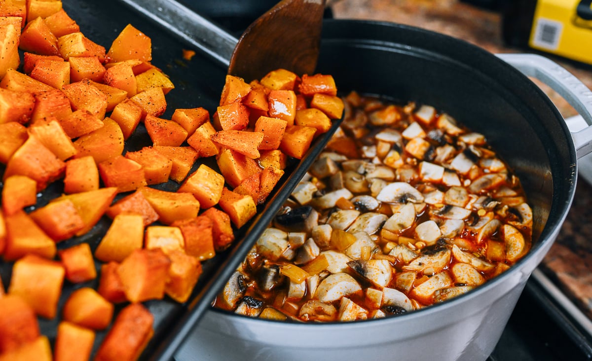 adding roasted squash to soup