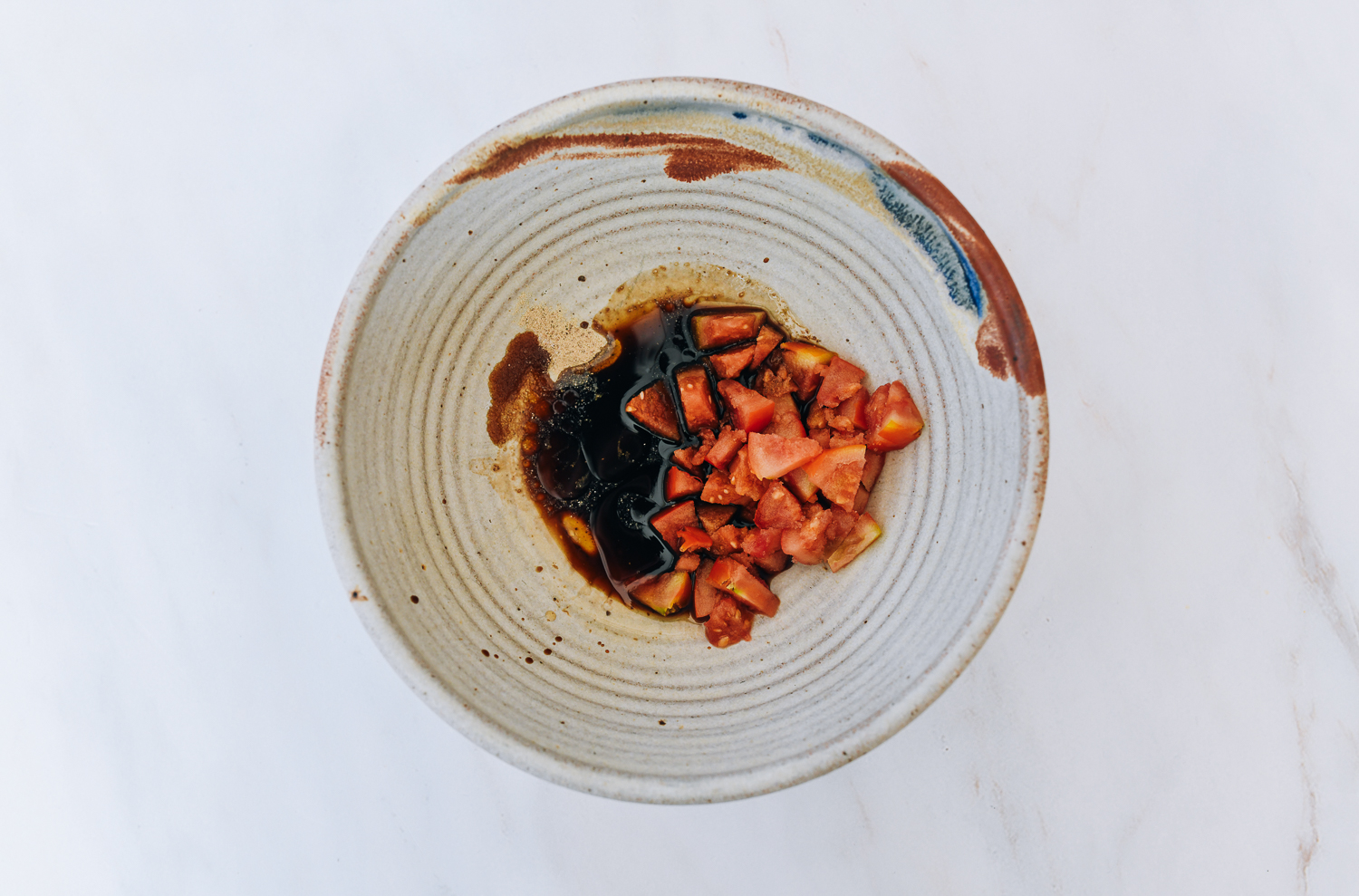 seasoning ingredients and tomato in large bowl