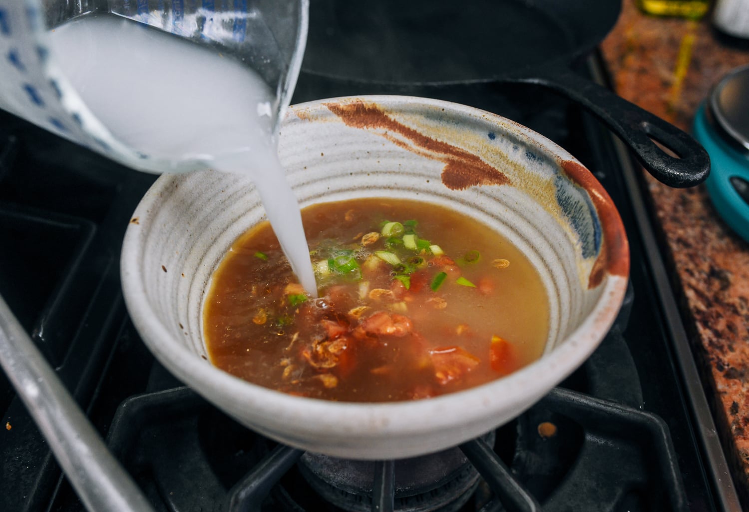 adding cooking water to bowl