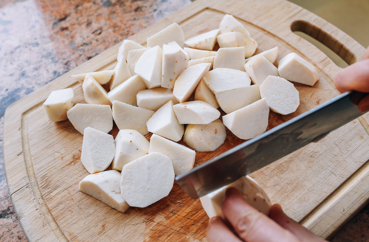 cutting small taro into chunks