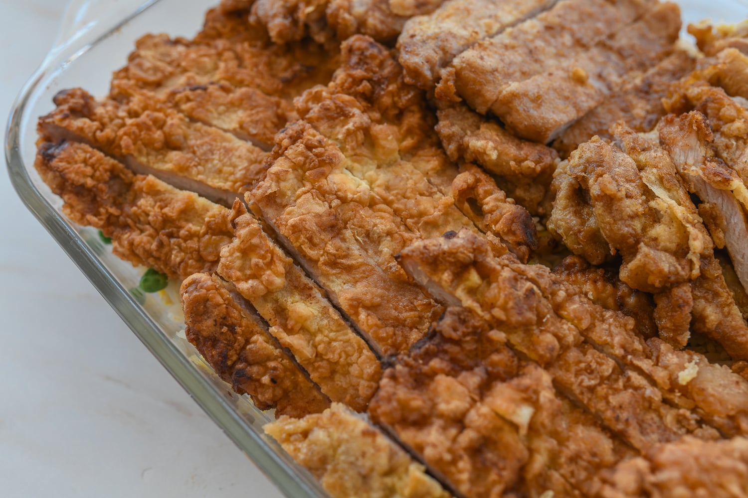 sliced pork chops layered in baking dish