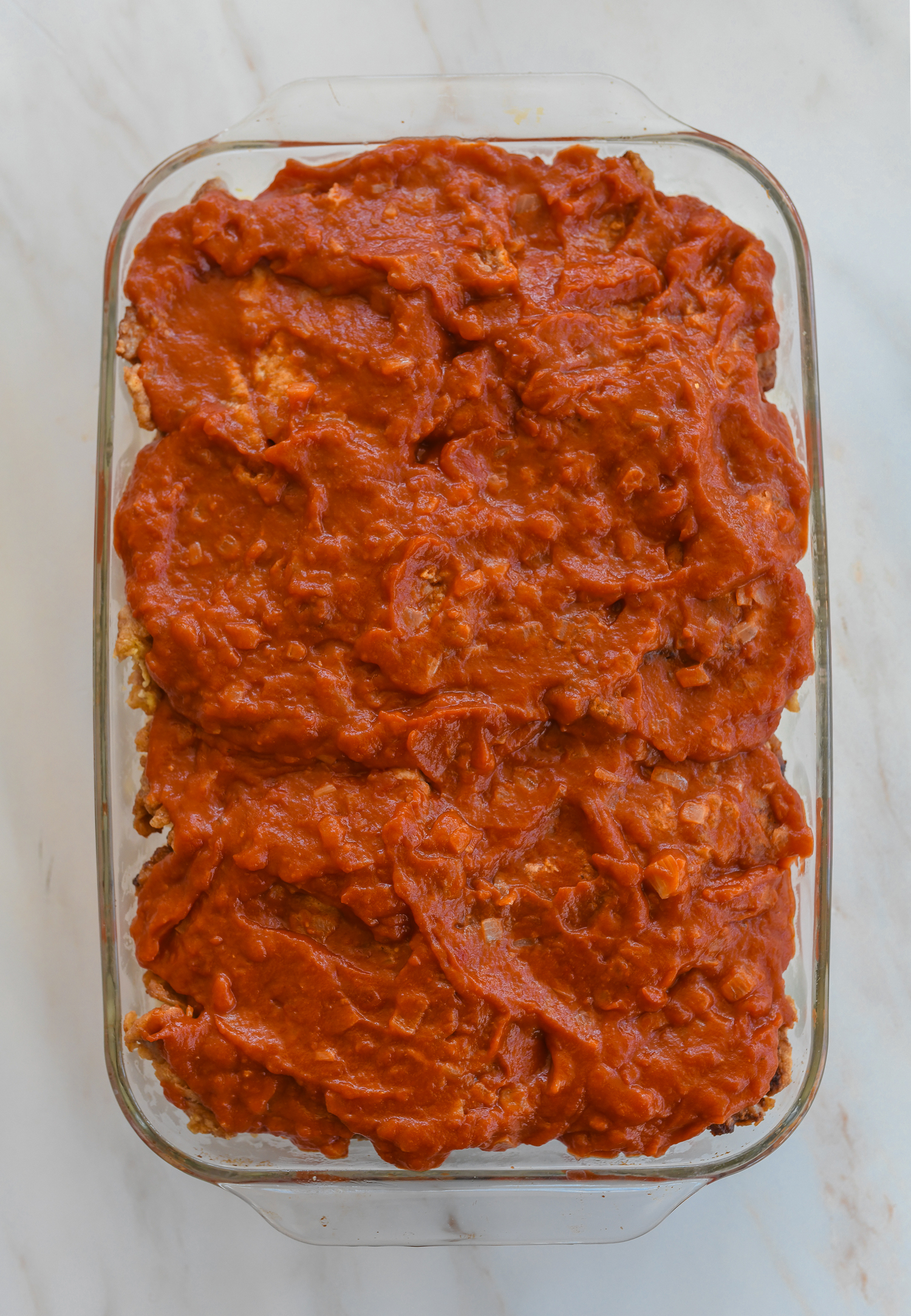 tomato sauce spread on pork chops and fried rice