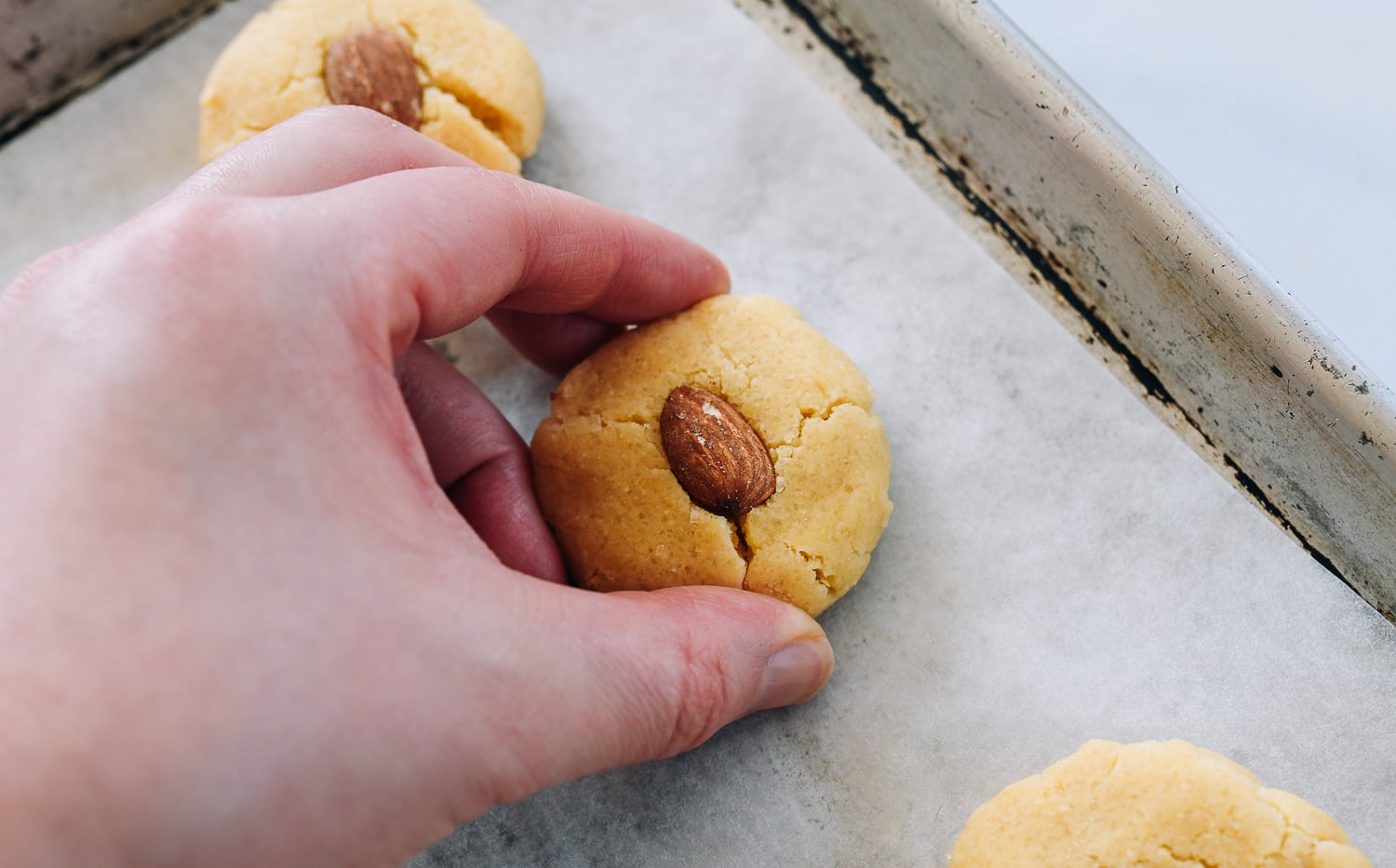 pushing together cracks in almond cookie dough
