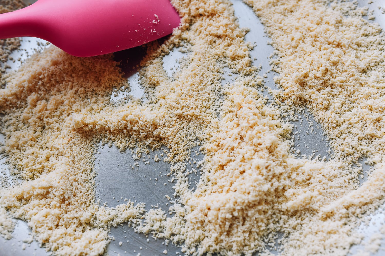 toasted almond flour in pan with spatula