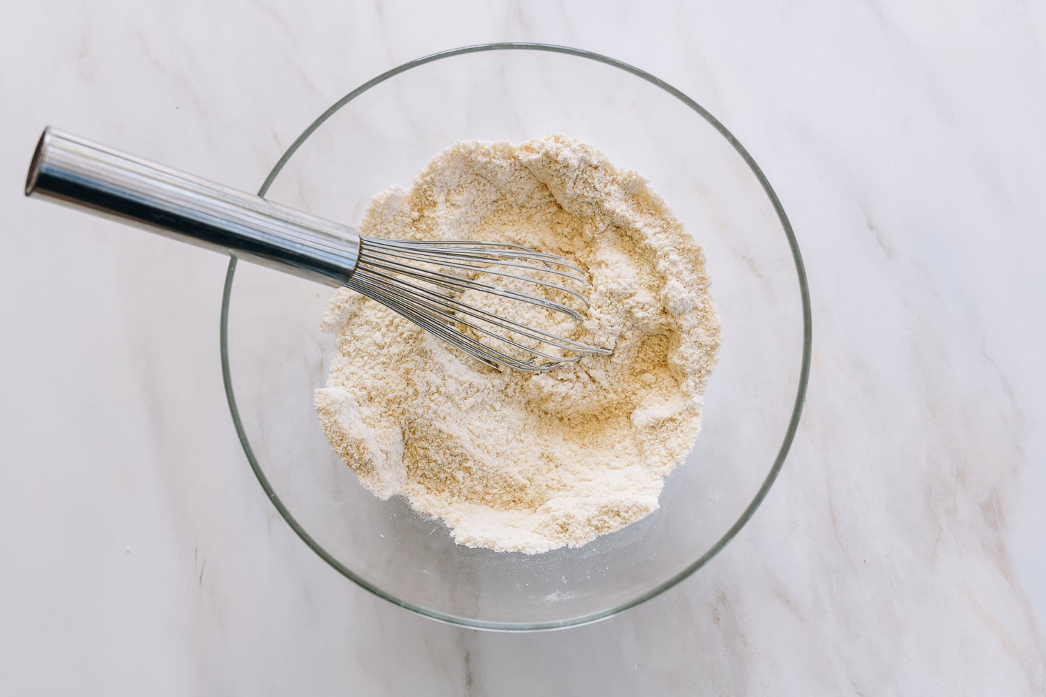whisking together dry ingredients for almond cookies